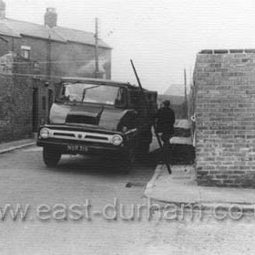 Rear of Alexandrina Street to left, rear of Frederick Street to right, looking west in the 1960s. Still common practice to have coals tipped in the street , they were then shovelled into the coalhouse through the coal-hatch in the wall. "Putting loads in" was a local industry.