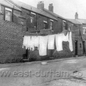 Rear of Alexandrina Street to left, rear of Frederick Street to right, looking west in the 1960s. Still common practice to hang washing out to dry in the street.